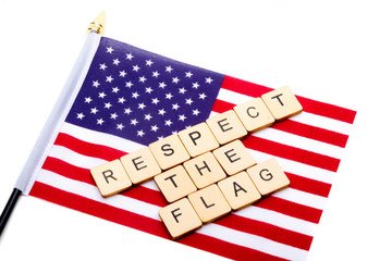 The flag of the United States isolated on a white background with a sign reading Respect The Flag