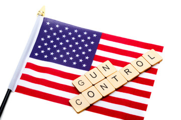 The flag of the United States isolated on a white background with a sign reading Gun Control