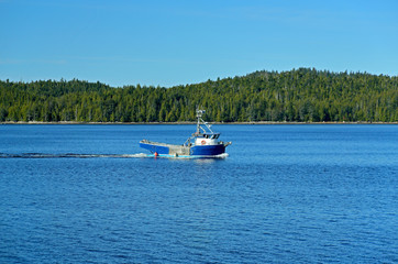 Boat on blue water with an island for background