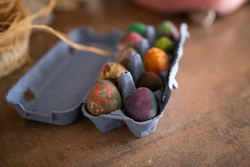 A dozen of painted Easter eggs in an egg box.