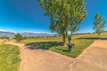 Scenic park with view of calm blue lake and snowy Timpanogos Mountains