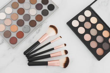 beauty industry and make-up products, eyeshadow palettes with nudes and bronzy tones with brushes