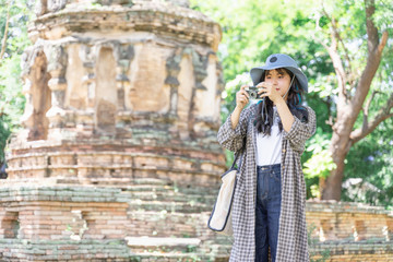 Fototapeta na wymiar Young woman traveler traveling in old temple. Asian tourist concept