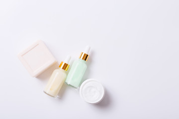 Herbal dermatology cosmetic skincare product in glass jar on white background