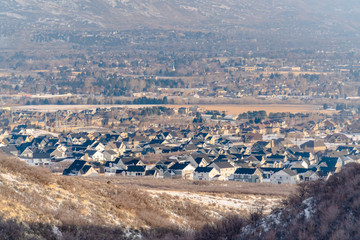 Houses in the suburbs amid hills covered with fresh snow on a cold winter day
