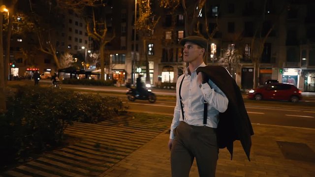Old Fashion Man from the 1920s england walking along an old street of a historic city at night. Lowlight