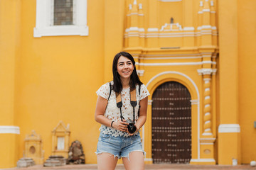 Traveling Latin Woman tourist backpackers taking photo in Mexico city