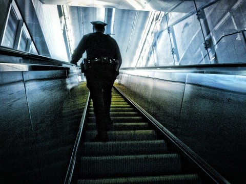 Police Officer On Subway Escalator