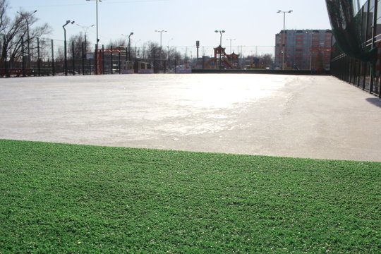 empty stadium with sports surface artificial grass for training