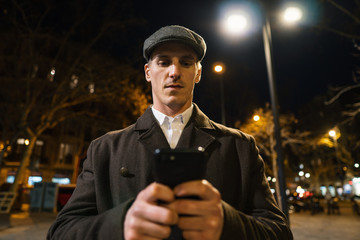 Old Fashion Man from the 1920s england walking along an old street of a historic city