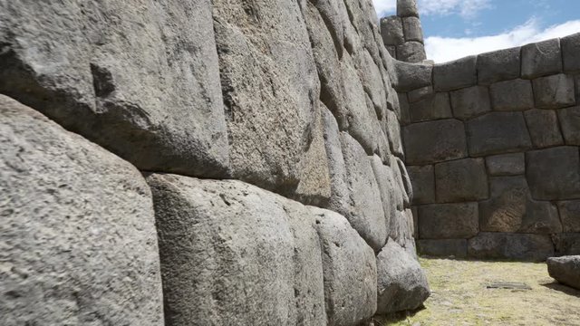 Huge massive stone blocks carved and rounded forming a defensive wall at ancient Inca fortress ruins of Sacsayhuaman in Cusco region, Peru. Famous Inca architecture and construction.