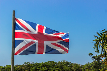 union jack blowing in the wind  on a clear day © derren