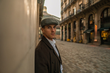 Old Fashion Man from the 1920s england walking along an old street of a historic city