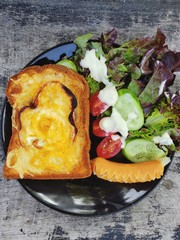 Bread, sausages, cheese and sauce with salad, top view