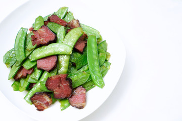 Chinese food fried bacon with peas. Stir fried peas with Chinese bacon