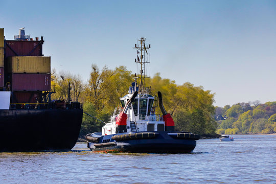 Hamburg Schlepper im Elber Hafen man&ouml;vriert ein Container Schiff