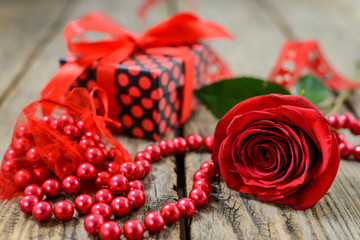 Rose, pearl necklace and gift