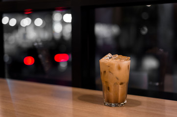 iced coffee put on wooden table in mini cafe