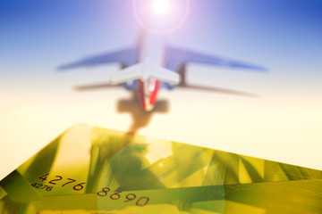 Travel concept background, bank card, airplane traveler, airline flying around the world, toned