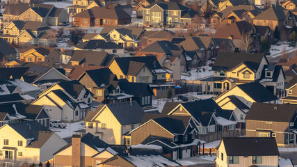 Panorama frame Houses with snowy roofs and snowy yards illuminated by sunlight in winter