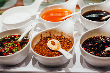 Mix of spices pepper, garlic. Paprika on the kitchen table. various kinds of spices in bowls - herbs and spices