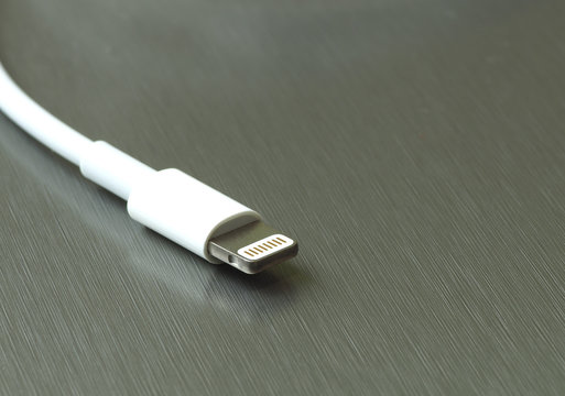 lightning white cable connector on a gray metal background