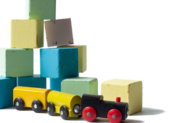 Color wood block and wooden train on white background.