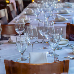 Photo Square frame Tableware arranged on round table with white cloth for eating at an occasion