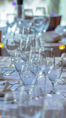 Vertical Wineglasses and tableware arranged on a table setting for a social gathering