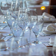 Square frame Wineglasses and tableware arranged on a table setting for a social gathering