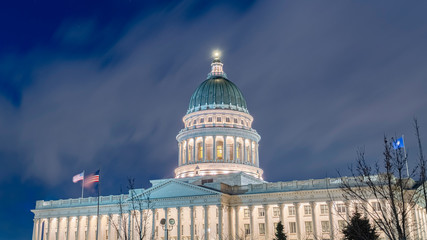 Fototapeta na wymiar Panorama Facade of majestic Utah State Capital Building glowing against sky and clouds