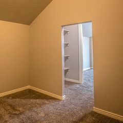 Square frame Empty room with carpet floor and view of closet through doorway without door