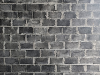 The brick wall has just been finished with cement and has not been smoothed. Construction material texture.