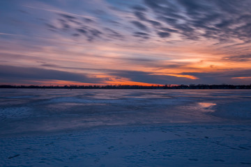 Fototapeta na wymiar Sunset twilight on a frozen lake