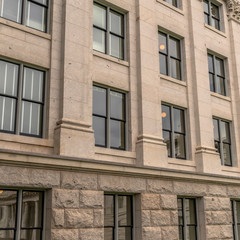 Square frame Building facade with decorative mouldings on the white stone exterior wall