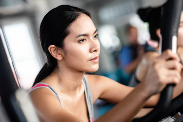 Fototapeta premium Young healthy woman bike cardio at the gym