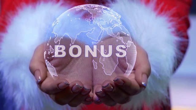 Female hands holding a conceptual hologram of planet Earth with text Bonus. Woman in red clothes with faux white fur with future holographic technology