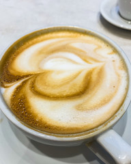 Coffee latte. Cup of coffee latte close up on a table, view from above