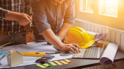 The engineer is giving advice and consulting with the designer to find out the construction site where the engineer will have to construct the project. Consultation between engineers and designers