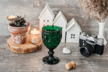 emerald glass with wine on the table in vintage style