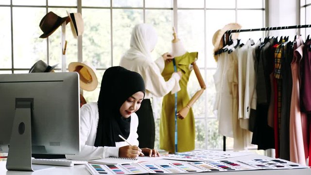 Muslim women fashion designers are in process of creating new clothes collection.