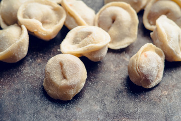 Raw dumplings in flour on the table. Russian national food. Selective focus.