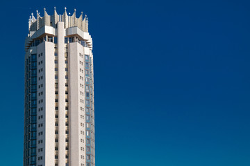 Almaty, Kazakhstan, October, 16, 2019, Hotel Kazakhstan. Top of tall building with crown against the vivid blue sky.