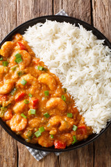 Shrimp Etouffee classic Louisiana stew is made with shrimp, onion, celery, and green pepper served with rice closeup on the table. Vertical top view