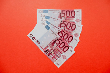 Euro in an envelope and without on a red background