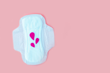 Protective menstrual pad with fabric blood drops on orange background. The concept of women gynecological health and intimate hygiene. Flat lay, copy space for text, close up