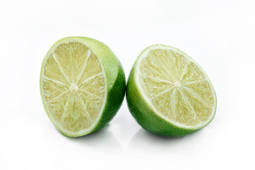 Two halves of lime on a white background