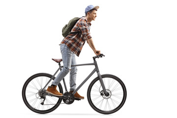 Male student standing and riding a bicycle