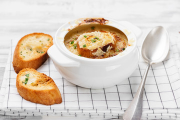 Homemade French onion soup with toasted baguette and melted cheese.