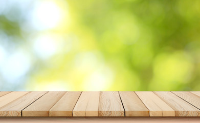 blurred background of green park in summer, Wood table top on shiny bokeh green background. For...